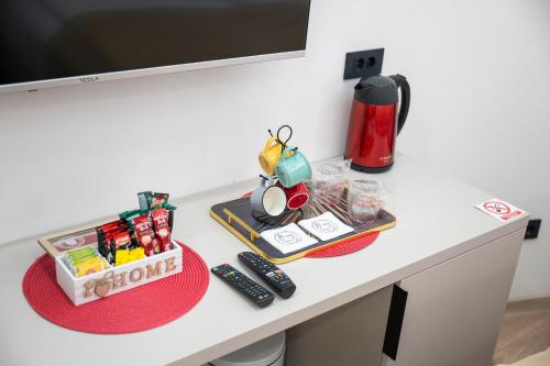 a desk in a room with a coffee maker and toys at Bella Suites Apartments - FREE PARKING-GARAGE in Sarajevo