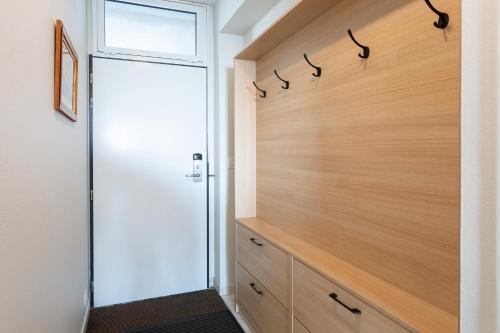 a pivot door in a bathroom with a walk in shower at Le Rêve les Pieds dans l'eau in La Tranche-sur-Mer
