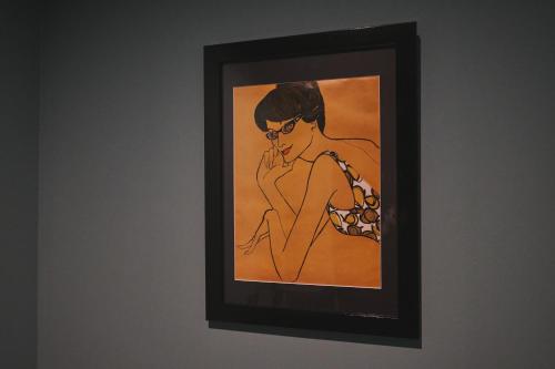 a painting of a woman in glasses on a wall at Little Deer by SANA in Tateyama