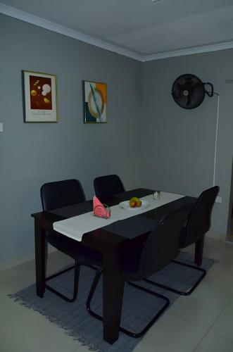 a table in a room with two chairs and a table at Lux-sit Guesthouse in Kasane
