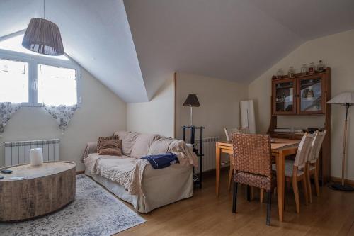 a living room with a couch and a table at Habitacion tranquila in Alpedrete