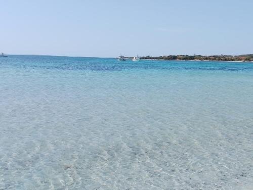 a large body of water with two boats in it at Casa Sofia in Putzu Idu