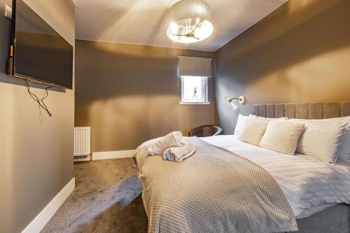a bedroom with a bed with a towel on it at Sandbed in Hawick