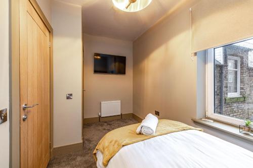 a bedroom with a bed and a window at Sandbed in Hawick