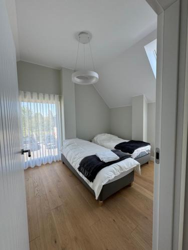 Postel nebo postele na pokoji v ubytování Nadmorskie Ostrowo