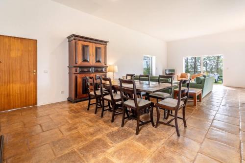 a dining room with a table and chairs at Casa Levante by HelloVacations in Tavira