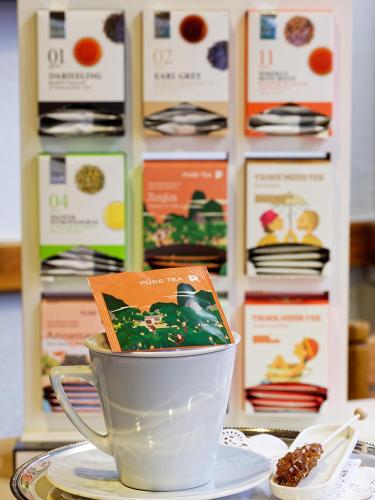 a cup on a table with a book in it at Gästehaus zur ehemaligen Mehlwaage wohnen und genießen in Bamberg