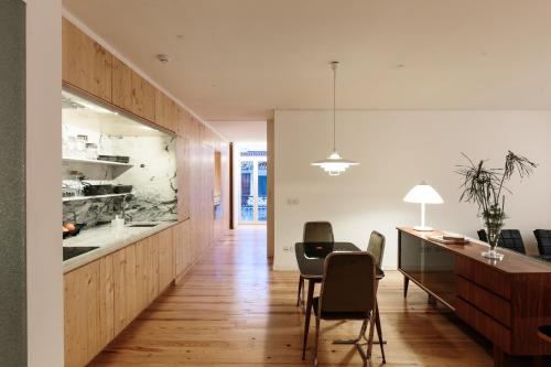 a kitchen and dining room with a table and chairs at samesame living in Lisbon