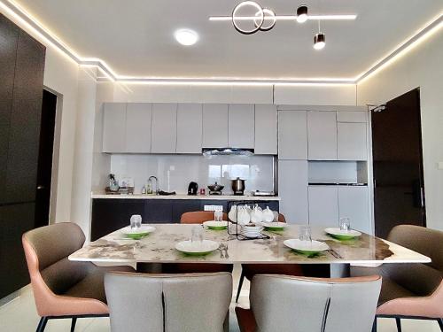 a kitchen with a table and chairs in a room at Astonishing Ocean View 3 Bedroom Apartment in Johor Bahru
