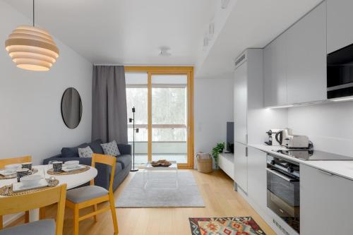a kitchen and living room with a couch and a table at Premium Nordic Design Studio in Central Location in Helsinki
