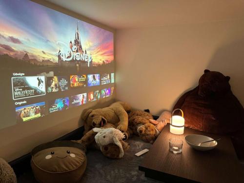 a group of stuffed animals sitting in a room with a tv at Copenhagen Collection King s Garden Studio in Copenhagen