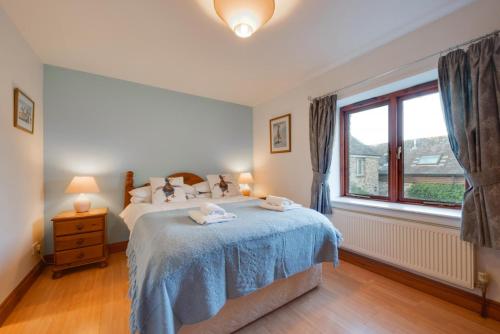 a bedroom with a bed and a window at Finest Retreats - Cherry at Buckland Court in Slapton