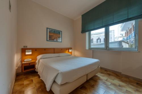 Postel nebo postele na pokoji v ubytování Hotel Barsotti