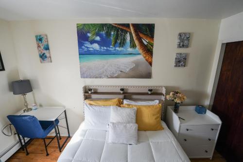 a bedroom with a bed with a picture of a beach at Chekells Cozy stay close to everything Free WIFI in Brooklyn