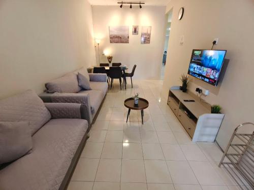 a living room with a couch and a table at Newcastle Seri Impian Snooker Ping Pong Neflix in Kluang