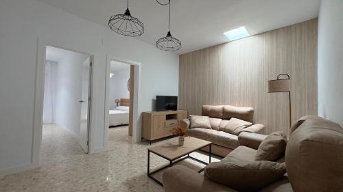 a living room with a couch and a table at Loft Central in Lepe