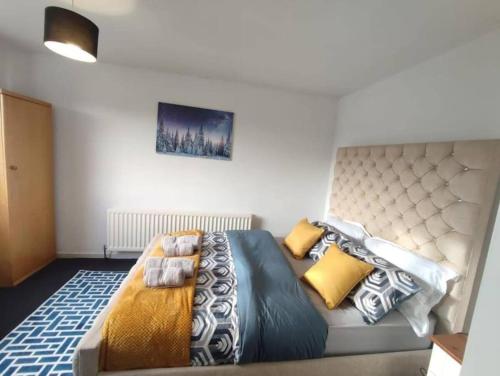 a bedroom with a large bed with pillows on it at Comfort Palace in Newcastle upon Tyne