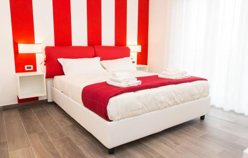 a red and white bedroom with a bed with red and white stripes at Sea Room Sorrento in Sorrento