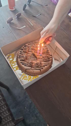 a person lighting a candle on a birthday cake at RKO Villa27 - Unawatuna in Habaraduwa