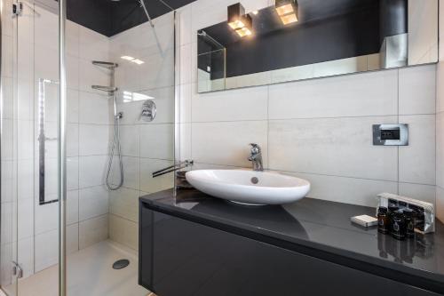 a bathroom with a sink and a shower at Dimora Einaudi in Alba