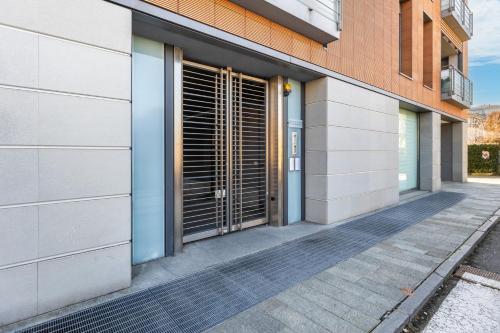 a facade of a building with doors and a sidewalk at Dimora Einaudi in Alba