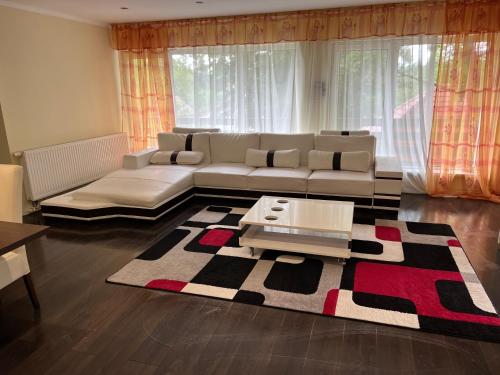 a living room with a couch and a rug at Panoráma vendégház in Mátraszentimre