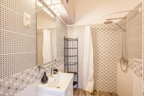 a bathroom with a sink and a shower at Two Couples Apartment in Budapest
