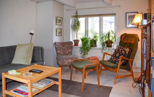 a living room with a couch and chairs and a table at 2 Bedroom Stunning Home In Simrishamn in Simrishamn