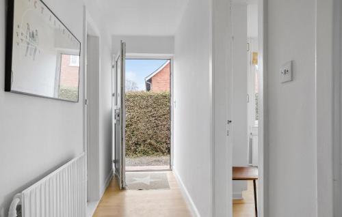 a hallway with white walls and a mirror at Amazing Home In Rønne With Wifi in Rønne