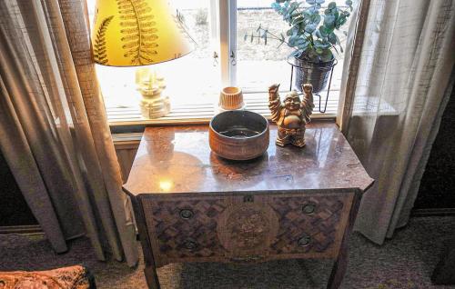 a table with a bowl on it next to a window at 3 Bedroom Awesome Home In Lessebo in Lessebo