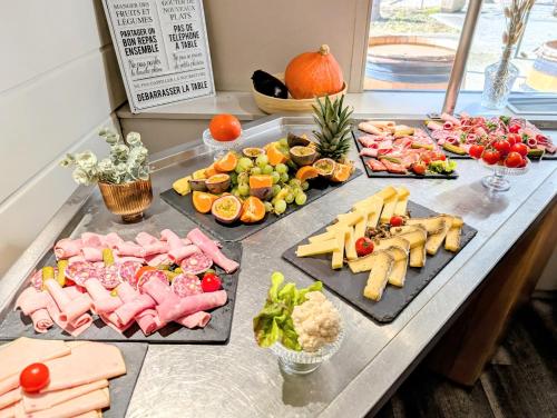 a buffet with different types of food on a table at Best Western Alexander Park Chambéry in Chambéry