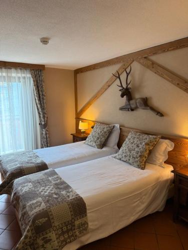 Un ou plusieurs lits dans un hébergement de l'établissement Hotel Jumeaux