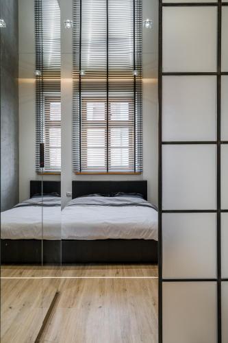 a bedroom with a bed and a window at Rynek 2B - Old Town in Wrocław