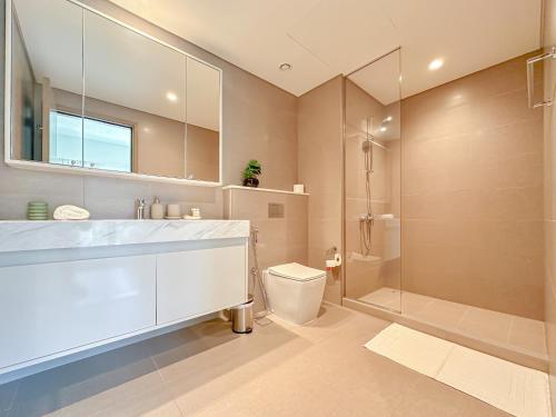 a bathroom with a sink and a toilet and a shower at Spectacular Burj Khalifa View, 2BR Luxury Apartment by SBH in Dubai