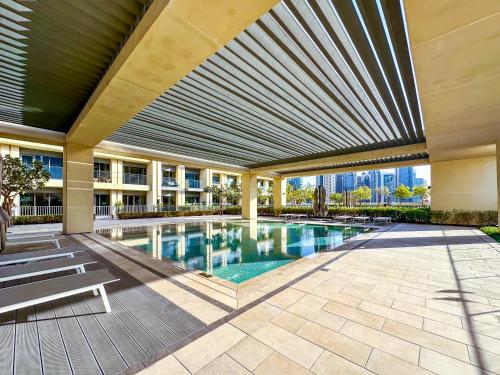 a swimming pool in a building with a ceiling at Spectacular Burj Khalifa View, 2BR Luxury Apartment by SBH in Dubai