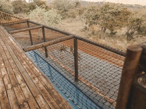 a fence on a bridge over a river at Thaba eNtle Private Boutique Game Farm in Thabazimbi