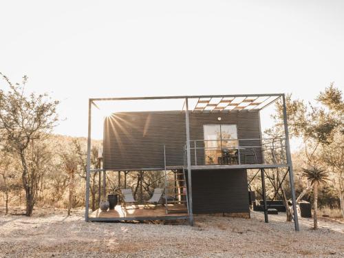 a house with a glass roof on a field at Thaba eNtle Private Boutique Game Farm in Thabazimbi