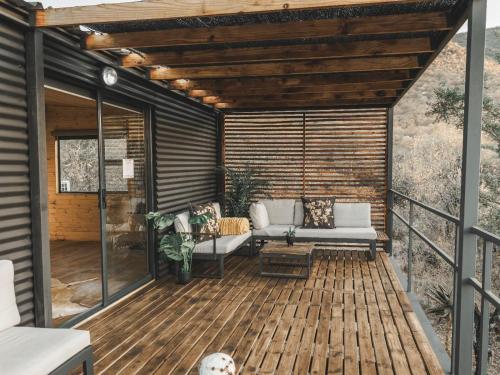 a screened in porch with a couch on a deck at Thaba eNtle Private Boutique Game Farm in Thabazimbi