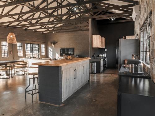a large kitchen with a counter and a refrigerator at Thaba eNtle Private Boutique Game Farm in Thabazimbi
