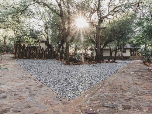 a stone walkway with trees in the background at Thaba eNtle Private Boutique Game Farm in Thabazimbi