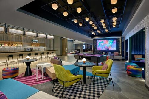 a lobby with a pool table and a bar at Aloft Bangkok - Sukhumvit 11 in Bangkok