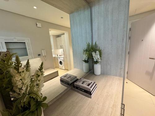 a view of a living room with plants and a television at Dubai Palm Jumeirah - Free Infiniti Pool and Private Beach in Dubai