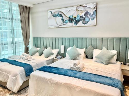 two beds sitting in a room with at Dubai Palm Jumeirah - Free Infiniti Pool and Private Beach in Dubai