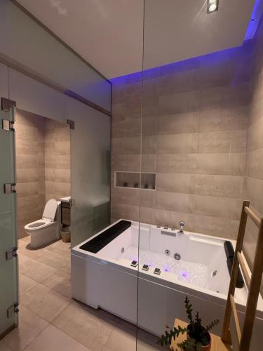 a bath tub in a bathroom with a toilet at شاليهات بالما in Al Hofuf