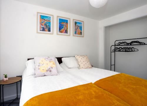 a bedroom with a large bed with two pillows at Stylish Seaside Stay - Spacious Ramsgate Apartment - New Build, Underfloor Heating, Perfect Location in Ramsgate