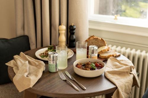 a table with plates of food and a bowl of food at Moment George IV Bridge in Edinburgh