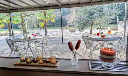 a room with two tables and chairs and a large window at Best Western Alexander Park Chambéry in Chambéry