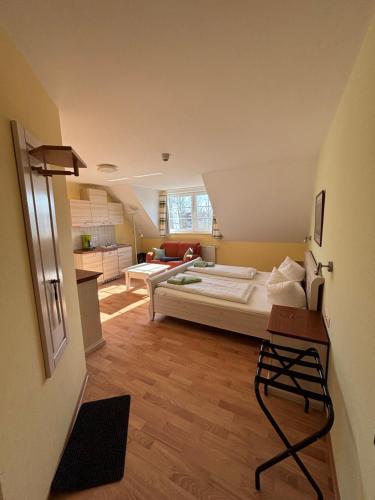 a bedroom with a bed and a living room at Spreewälder Feriendomizil/Pension in Burg