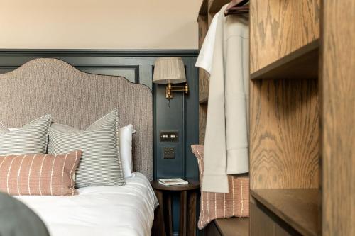 a bedroom with a bed with a large headboard at Moment George IV Bridge in Edinburgh
