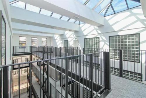 a large building with a glass ceiling and a balcony at Stylish Seaside Stay - Spacious Ramsgate Apartment - New Build, Underfloor Heating, Perfect Location in Ramsgate